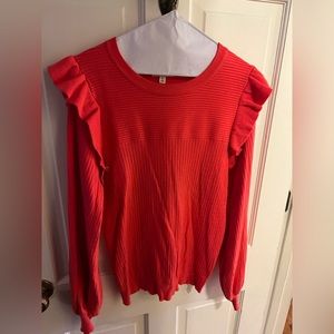 Bright pink ribbed sweater with ruffle detail